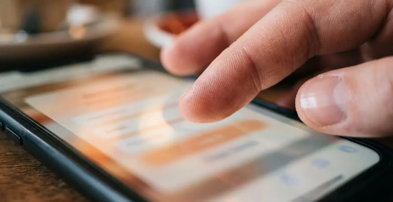Close-up of hands typing on mobile phone during checkout